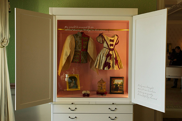 Display case of Queen Victoria children's clothes in the Family Room. The case features outfits worn by Victoria's eldest children - Bertie and Vicky.